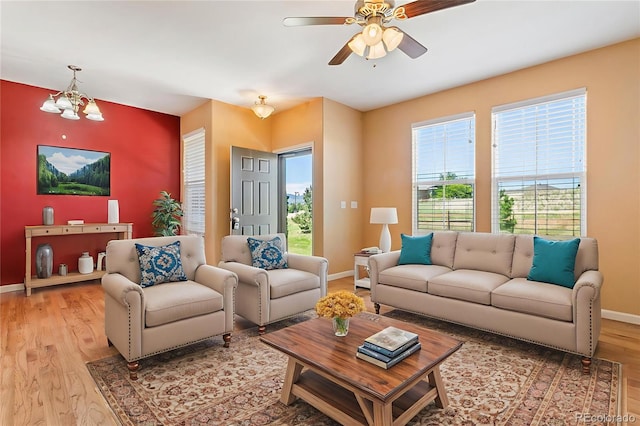 1284 Timber Run Hts, Monument, CO 80132 - living area with light wood-style flooring, a ceiling fan, and a chandelier