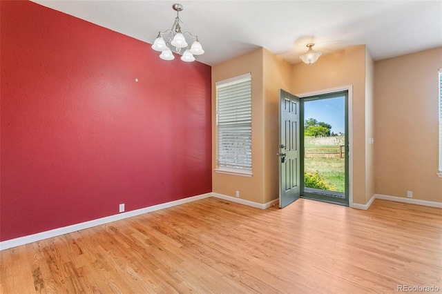 1284 Timber Run Hts, Monument, CO 80132 - spare room with wood finished floors and a chandelier