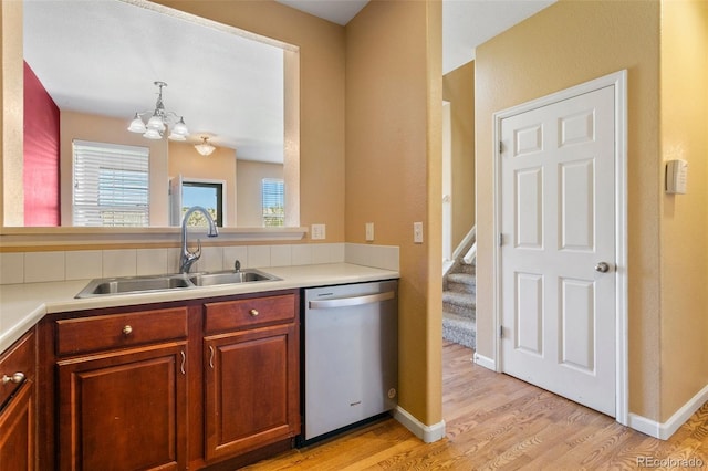 1284 Timber Run Hts, Monument, CO 80132 - kitchen featuring dishwasher, a chandelier, light wood-style floors, light countertops, and pendant lighting