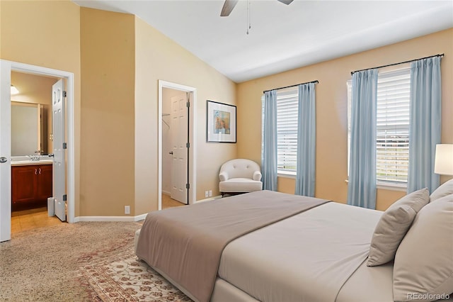 1284 Timber Run Hts, Monument, CO 80132 - bedroom featuring lofted ceiling, multiple windows, light carpet, ensuite bathroom, and ceiling fan