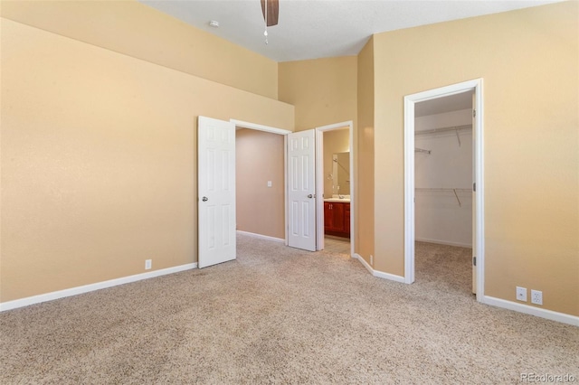 1284 Timber Run Hts, Monument, CO 80132 - unfurnished bedroom featuring carpet flooring, a walk in closet, a closet, high vaulted ceiling, and a ceiling fan