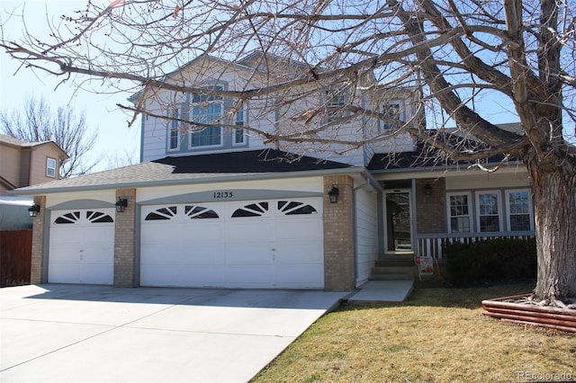 traditional home featuring brick siding, driveway, and a shingled roof