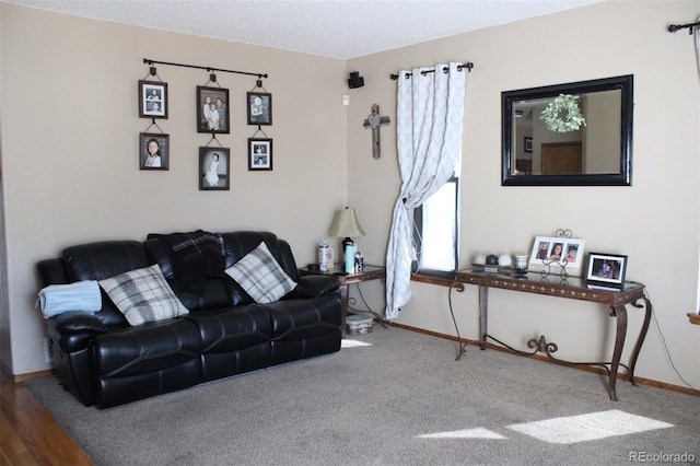 carpeted living area with baseboards