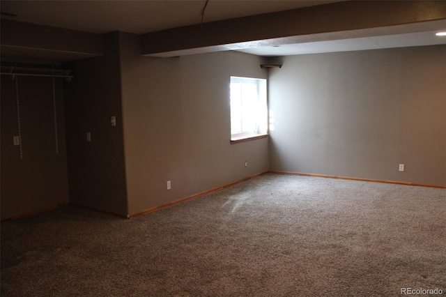 below grade area featuring baseboards and carpet