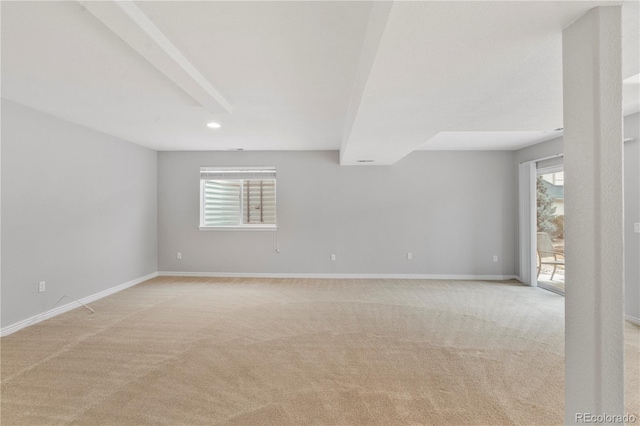 empty room with baseboards and light colored carpet