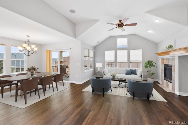 living room with plenty of natural light, lofted ceiling, dark wood finished floors, and a fireplace