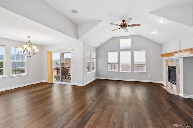 unfurnished living room with vaulted ceiling, baseboards, dark wood-style flooring, and a tile fireplace