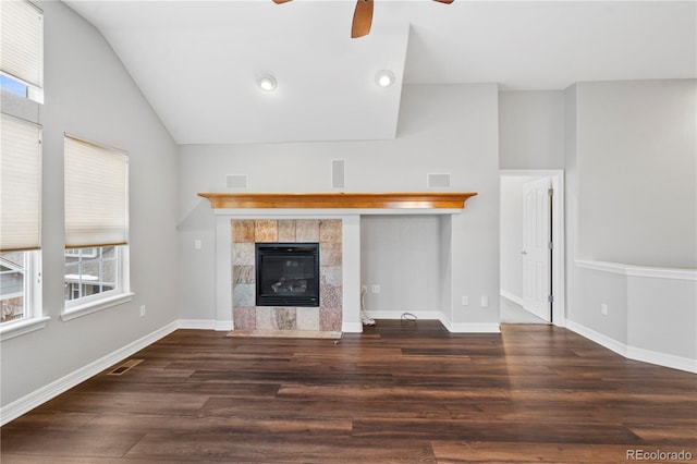 unfurnished living room featuring plenty of natural light, wood finished floors, a fireplace, and vaulted ceiling