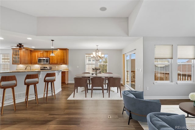 dining space featuring a wealth of natural light, visible vents, baseboards, and dark wood-style flooring