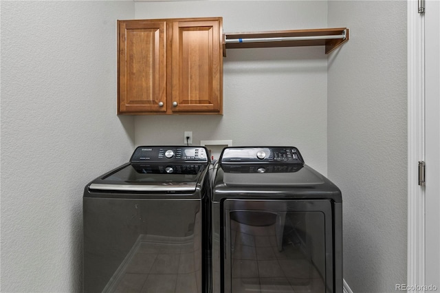 washroom featuring cabinet space and washing machine and dryer