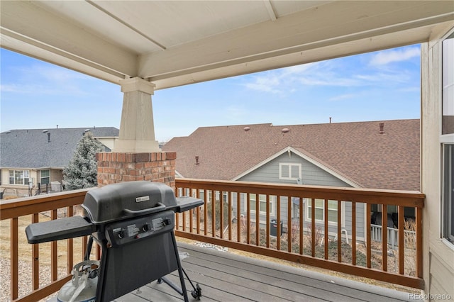 wooden deck featuring a grill