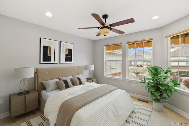 bedroom featuring visible vents, multiple windows, and baseboards