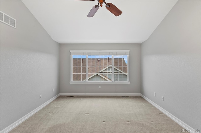 carpeted empty room with visible vents, baseboards, and ceiling fan