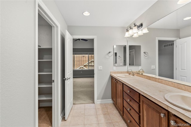 full bathroom with double vanity, visible vents, tile patterned floors, and a sink