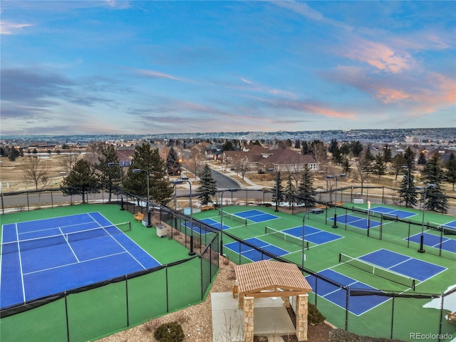 view of tennis court featuring fence