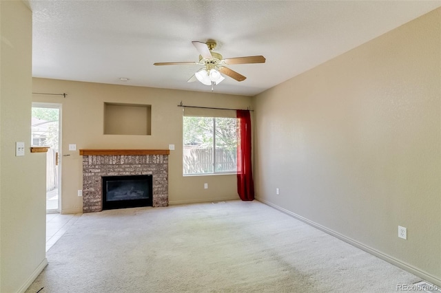 2035 Overland Dr, Brighton, CO 80601 - unfurnished living room with a fireplace, carpet, a ceiling fan, and baseboards
