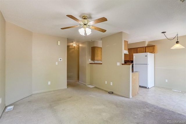 2035 Overland Dr, Brighton, CO 80601 - unfurnished living room with ceiling fan, baseboards, and light carpet
