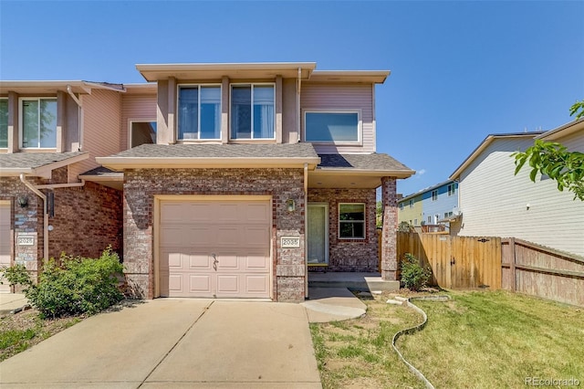 2035 Overland Dr, Brighton, CO 80601 - view of front of house featuring a garage, brick siding, and concrete driveway
