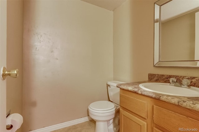 2035 Overland Dr, Brighton, CO 80601 - bathroom with toilet, vanity, tile patterned floors, and baseboards
