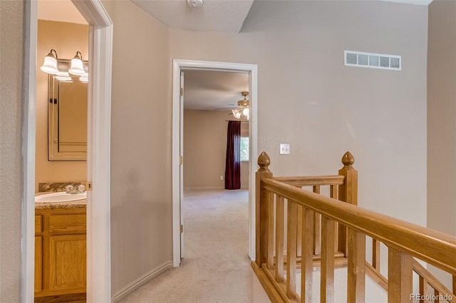 2035 Overland Dr, Brighton, CO 80601 - hallway featuring an upstairs landing, light colored carpet, and a sink
