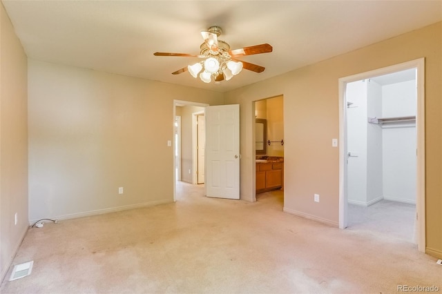 2035 Overland Dr, Brighton, CO 80601 - unfurnished bedroom with light carpet, a spacious closet, baseboards, connected bathroom, and a closet