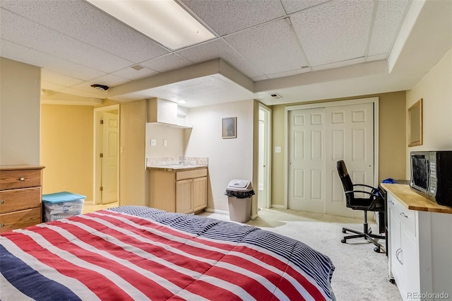 2035 Overland Dr, Brighton, CO 80601 - bedroom featuring light colored carpet, a paneled ceiling, a closet, and an office area