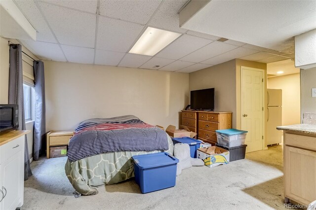 2035 Overland Dr, Brighton, CO 80601 - bedroom featuring freestanding refrigerator, a paneled ceiling, and light carpet