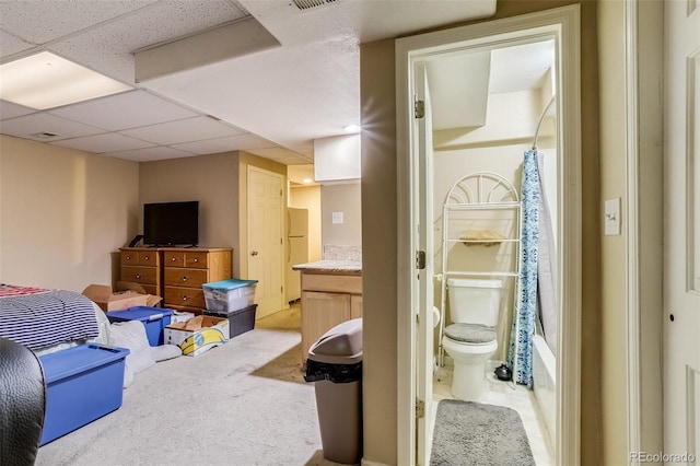 2035 Overland Dr, Brighton, CO 80601 - bedroom with connected bathroom, freestanding refrigerator, and light colored carpet
