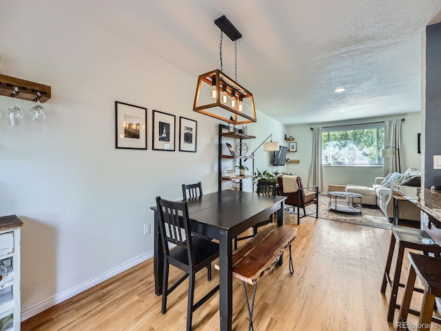 6664 Gray St, Arvada, CO 80003 - dining area with light wood-style flooring and a textured ceiling