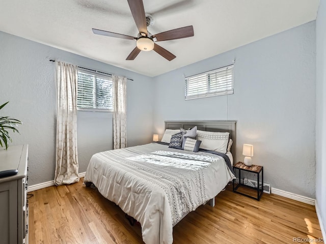 6664 Gray St, Arvada, CO 80003 - bedroom with light wood-style flooring, a textured wall, and ceiling fan