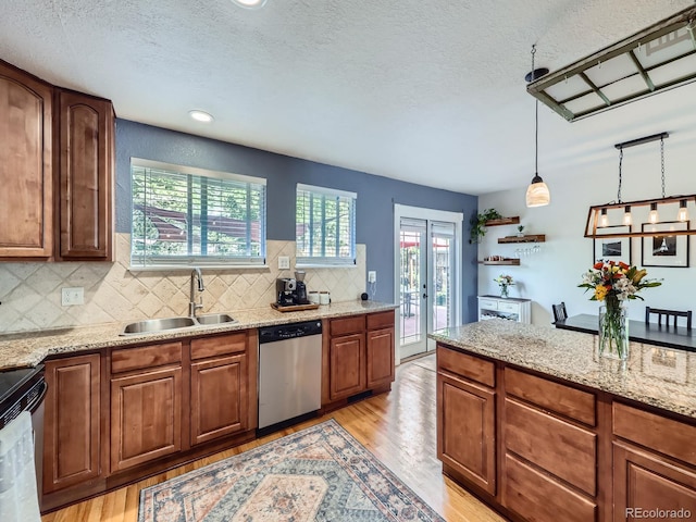 6664 Gray St, Arvada, CO 80003 - kitchen featuring appliances with stainless steel finishes, light wood-type flooring, backsplash, a textured ceiling, and recessed lighting