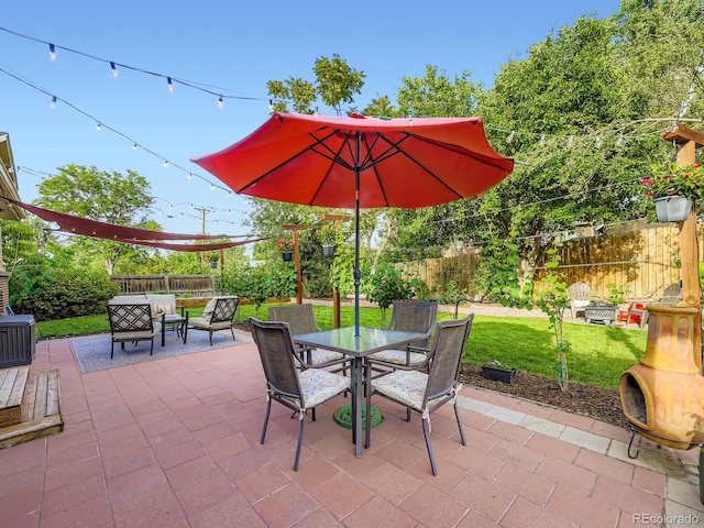 6664 Gray St, Arvada, CO 80003 - fenced backyard with a patio area, outdoor dining space, and an outdoor living space
