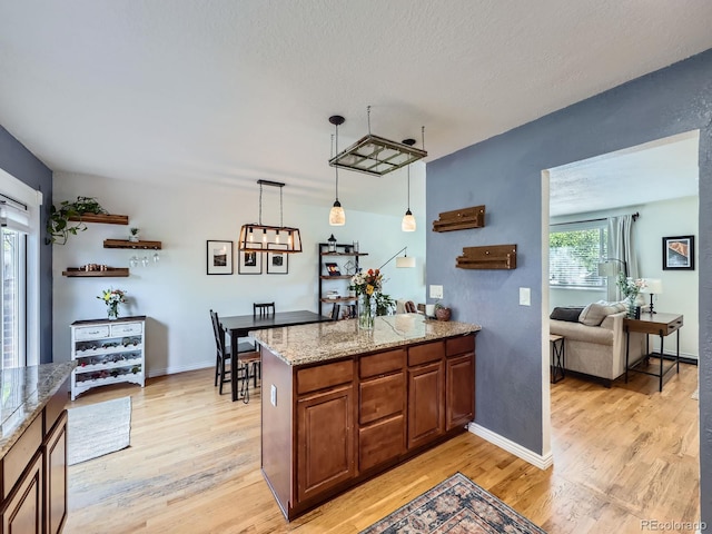6664 Gray St, Arvada, CO 80003 - bar featuring light wood-type flooring and hanging light fixtures