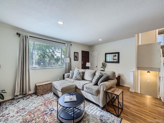6664 Gray St, Arvada, CO 80003 - living area with light wood-style flooring, a textured ceiling, and recessed lighting