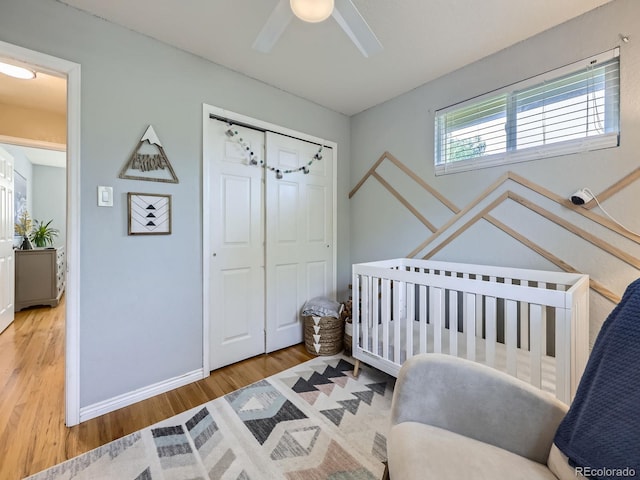 6664 Gray St, Arvada, CO 80003 - bedroom with wood finished floors, a closet, ceiling fan, and a crib