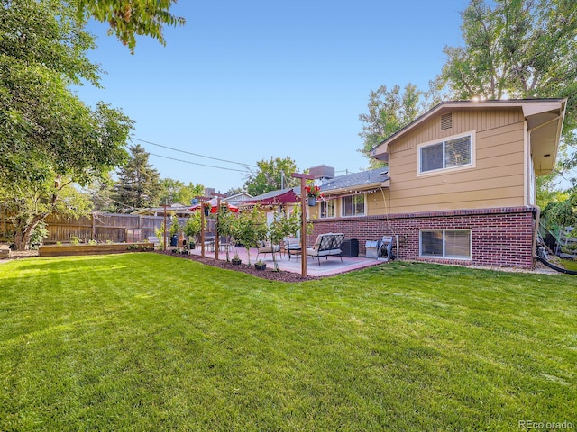 6664 Gray St, Arvada, CO 80003 - back of property featuring a patio area and brick siding