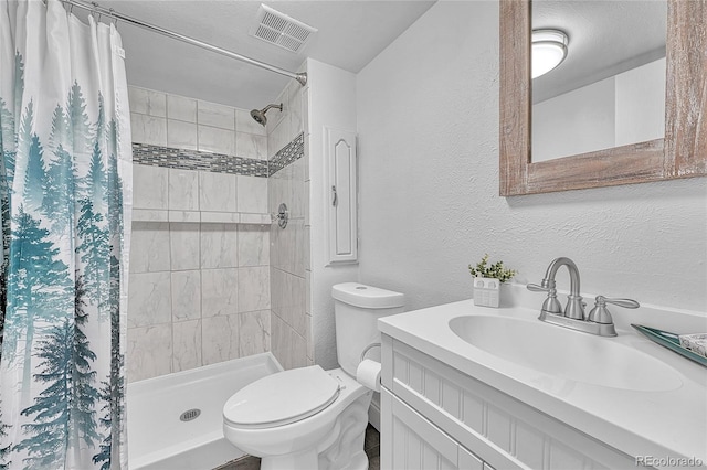4726 S Taft St, Morrison, CO 80465 - bathroom featuring a textured wall, vanity, and a tile shower