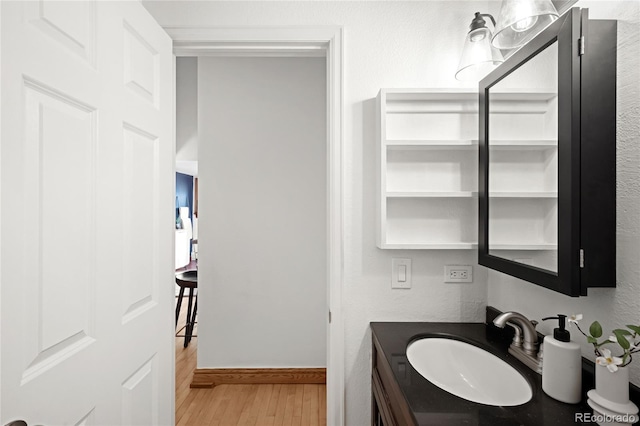 2351 Federal Blvd Unit 102, Denver, CO 80211 - bathroom with wood finished floors, vanity, and baseboards