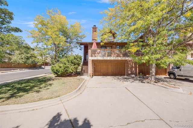 log cabin with stairs, an attached garage, a chimney, and driveway