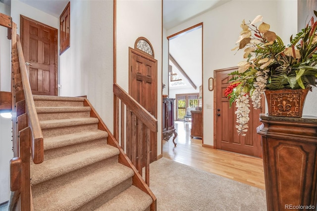 entryway with light wood-style floors and stairs