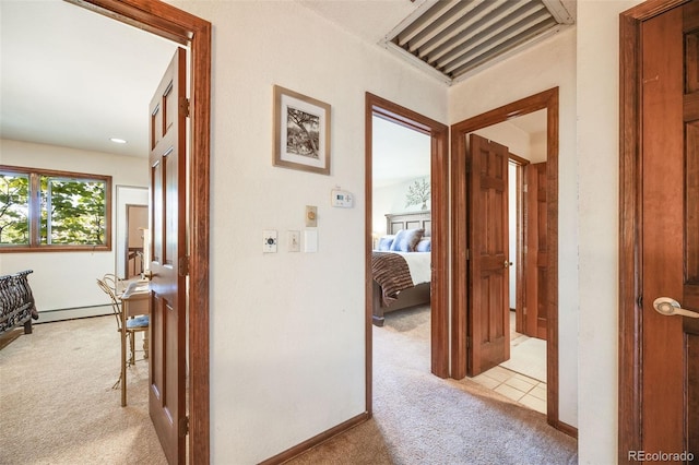 corridor featuring carpet and baseboard heating
