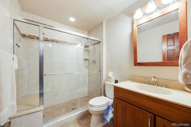 full bathroom with vanity, tile patterned floors, a stall shower, and toilet