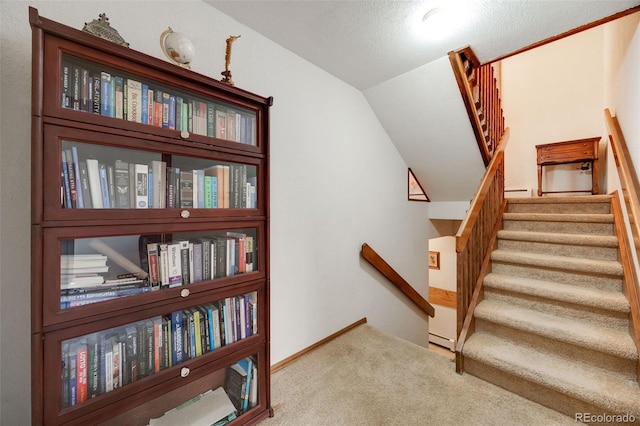 staircase with carpet flooring and lofted ceiling