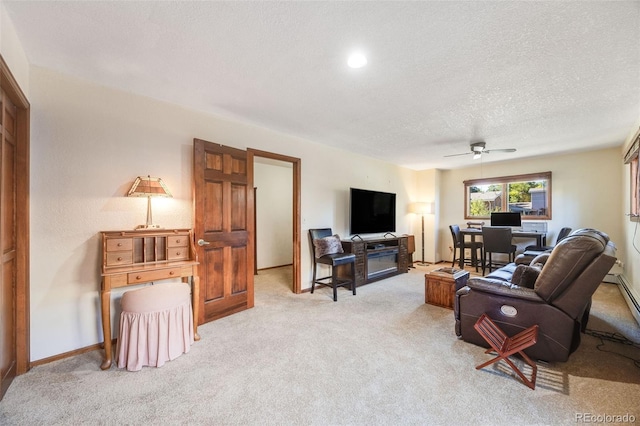 living room with a ceiling fan, a textured ceiling, and light colored carpet