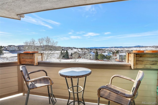 view of snow covered back of property