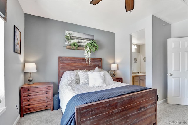 carpeted bedroom featuring ceiling fan and connected bathroom