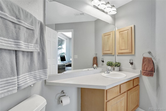 bathroom featuring vanity and toilet