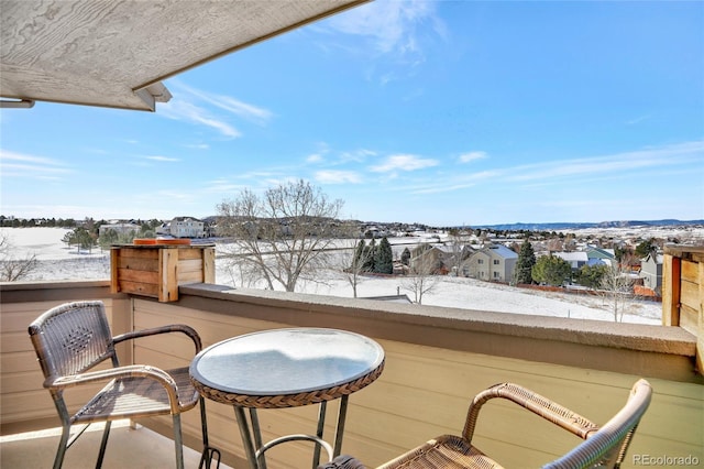 view of snow covered back of property