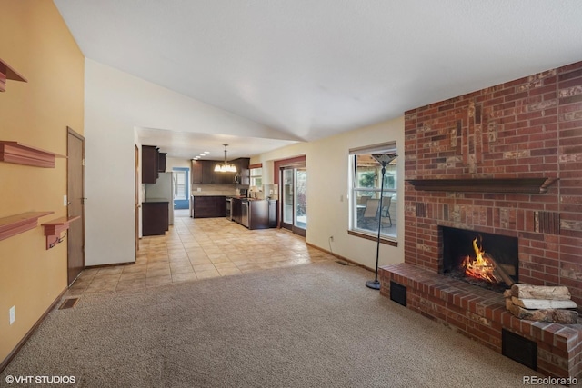 unfurnished living room with light colored carpet, lofted ceiling, and a brick fireplace