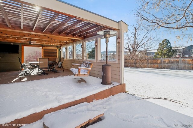 snow covered patio featuring a pergola